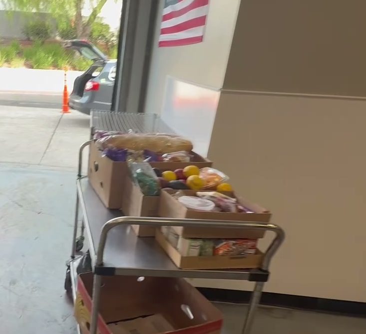 A packed food cart waiting at the open garage door for load-out