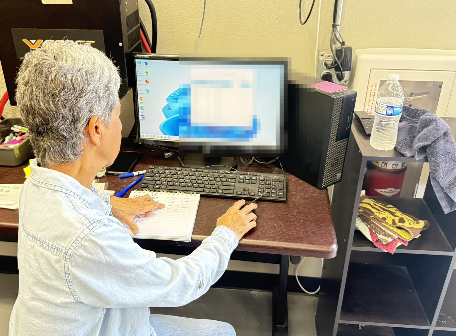 Staff member working a floor workstation with Food Pantry System during distribution